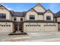 Charming townhome featuring a well-manicured lawn and a two-car garage for convenient parking and storage at 4205 Douro Trl, Westfield, IN 46062