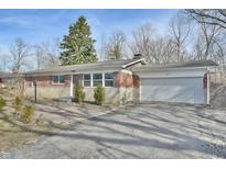 Brick ranch home with attached garage and landscaped yard at 4575 Ayrshire St, Indianapolis, IN 46228