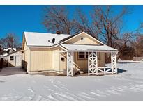 Charming single-story home with a covered porch, nestled in a snow-covered landscape at 4632 Normal Ave, Indianapolis, IN 46226