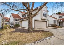 Charming two-story home features attached garage, landscaped front yard, and mature trees at 6412 Bay Vista Ct, Indianapolis, IN 46250