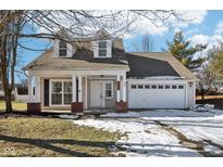 Two-story house with a light beige exterior, white garage door, and a covered porch at 10322 Sage Ct, Noblesville, IN 46060
