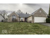 Brick ranch house with attached garage and well-maintained lawn at 12639 Pine Grove Ct, Indianapolis, IN 46236