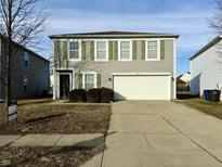 Two-story house with attached garage, green shutters, and landscaping at 1338 Central Park Dr, Shelbyville, IN 46176