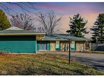 Charming stone and siding home with a well-maintained yard and attached garage at 1442 Northbrook Dr, Indianapolis, IN 46260
