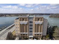 Aerial view of a luxury condo building overlooking a river at 420 W Jackson St # 42, Cicero, IN 46034