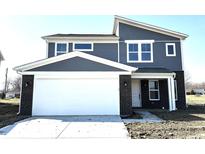 Two-story home featuring a gray-blue exterior, white trim, a two-car garage, and a well-manicured lawn at 450 Atlas Dr, Lebanon, IN 46052