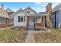 Charming home with a walkway leading to a covered porch and brick accents at 55 E Regent St, Indianapolis, IN 46225