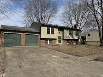 Ranch home with two-car garage and landscaped yard at 6044 Granner Dr, Indianapolis, IN 46221
