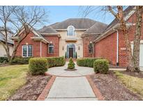 Beautiful brick two-story home featuring a walkway leading to a grand entrance and manicured landscaping at 6437 N Oxbow Way, Indianapolis, IN 46220