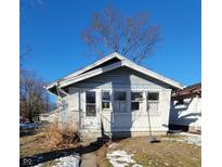 Light blue bungalow with white brick accents and small front yard at 710 N Drexel Ave, Indianapolis, IN 46201