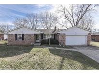 Brick ranch house with attached garage and large yard at 105 Kenova Dr, Indianapolis, IN 46227
