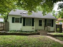 Charming single story home with green shutters and stone accents at 1726 N Linwood Ave, Indianapolis, IN 46218