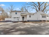 Charming white house with a detached garage and a well-manicured lawn at 1866 W 57Th St, Indianapolis, IN 46228