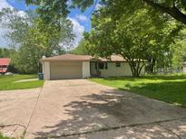 Charming single-story home featuring a convenient two-car garage and a sprawling front yard at 5324 Mann Rd, Indianapolis, IN 46221