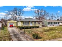 Ranch house with yellow siding, attached garage, and landscaped yard at 671 Van Ave, Shelbyville, IN 46176