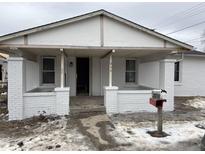 Newly painted white brick home with a covered porch at 859 E Gray St, Martinsville, IN 46151