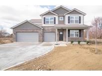 Beautiful two-story home featuring a brick facade, covered porch, and a spacious two-car garage at 101 Ames Dr, Whiteland, IN 46184