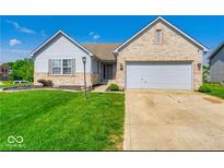 Brick ranch home with attached garage and well-manicured lawn at 1296 Shortridge Dr, Greenwood, IN 46143