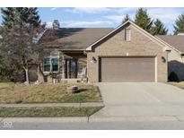 Brick ranch home with attached garage and landscaped yard at 1642 Foxmere Blvd, Greenwood, IN 46142