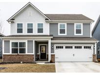 Charming two-story home with a two-car garage, brick accents, gray siding, and a welcoming front entrance at 2242 Egbert Rd, Westfield, IN 46074