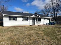 White ranch house with black roof, landscaping, and attached garage at 2708 E 26Th St, Muncie, IN 47302