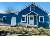 Charming blue two-story home with white trim and a covered front porch at 310 S Gerrard Dr, Indianapolis, IN 46241