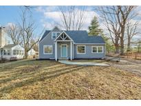 Gray house with a light blue door and a landscaped yard at 3229 Brill Rd, Indianapolis, IN 46227