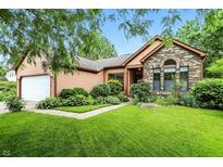 Charming home exterior with brick and siding, plus a well-manicured lawn and landscaping at 4646 Rocky Knob Ln, Indianapolis, IN 46254