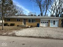 Brick ranch home with attached garage and landscaped yard at 6107 Hazelhatch Dr, Indianapolis, IN 46228