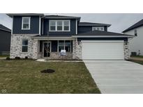 Charming two-story home featuring a two-car garage, brick accents, and a well-manicured lawn at 6322 Stone Side Dr, Plainfield, IN 46168