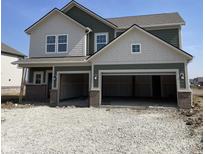 Two-story home featuring a two-car garage, varied siding, and brick facade accents at 8885 Lowell St, McCordsville, IN 46055