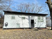 Ranch home with gray siding, black accents, and a landscaped yard at 9508 Conried Dr, Indianapolis, IN 46235