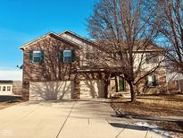 Traditional brick home featuring a two-car garage, green shutters, and a well-maintained front yard at 11716 Crab Apple Rd, Indianapolis, IN 46239