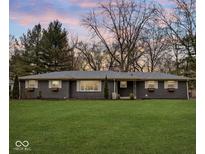 Charming single-story home with a well-manicured lawn, brick facade, and inviting curb appeal at 1403 Shawnee Rd, Indianapolis, IN 46260