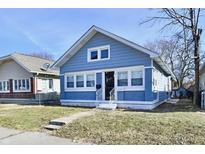 Charming bungalow with a light blue exterior, white trim, and inviting front porch at 1425 N Mount St, Indianapolis, IN 46222