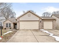 Charming single-story home with a spacious two-car garage and well-maintained front yard at 2427 Manita Dr, Indianapolis, IN 46234