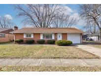 Brick ranch house with attached garage and well-maintained lawn at 2832 S Oakland Ave, Indianapolis, IN 46203