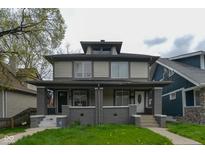 Two-story home with gray siding and a brick facade at 2921 N Talbott St, Indianapolis, IN 46205