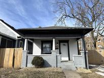 Charming home featuring a welcoming front porch and gray and white exterior paint at 3754 Graceland Ave, Indianapolis, IN 46208