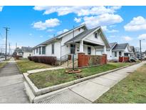 Charming two-story home with inviting front porch and well-manicured lawn at 403 Colescott St, Shelbyville, IN 46176