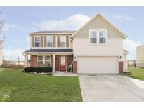 Two-story house with beige siding, red brick accents, and a two-car garage at 55 Markleville Ln, Westfield, IN 46074