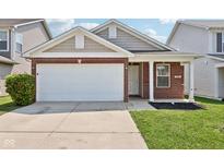 Brick and shingle ranch home with attached garage and landscaping at 573 New Moon St, Avon, IN 46123