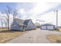 Gray farmhouse with detached garage and spacious yard at 5965 Grassy Rd, Lebanon, IN 46052