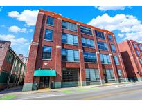 Brick building with large windows and green awning at 630 N College Ave # 401, Indianapolis, IN 46204