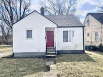 Charming single-story home featuring a red front door and a classic white exterior at 711 W 24Th St, Anderson, IN 46016