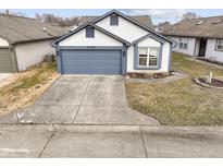 White house with gray garage door and landscaping; nice curb appeal at 7142 Eagle Cove S Dr, Indianapolis, IN 46254