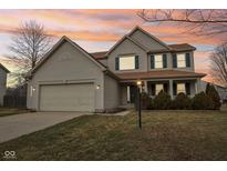 Two story home with a two car garage, covered porch, and manicured lawn at 7144 Gwinnett Pl, Noblesville, IN 46062