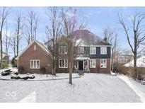 Charming brick home featuring a beautifully maintained lawn and welcoming front porch at 8749 Calumet Dr, Indianapolis, IN 46236