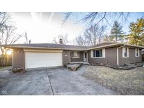 Charming brick ranch-style home with attached garage and well-maintained front yard at 1340 N Routiers Ave, Indianapolis, IN 46219
