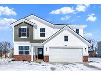 Two-story home showcasing white siding, grey accents, brick foundation, and an attached two-car garage at 1560 Covington Blvd, Franklin, IN 46131
